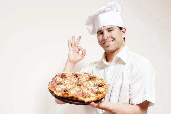 Glad attraktiva kock med en pizza — Stockfoto