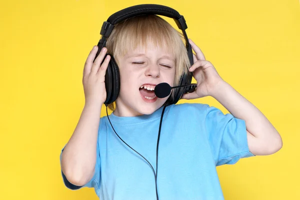 The emotional kid in ear-phones — Stock Photo, Image