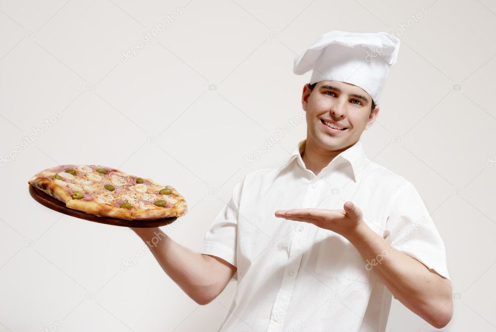 Happy attractive cook with a pizza