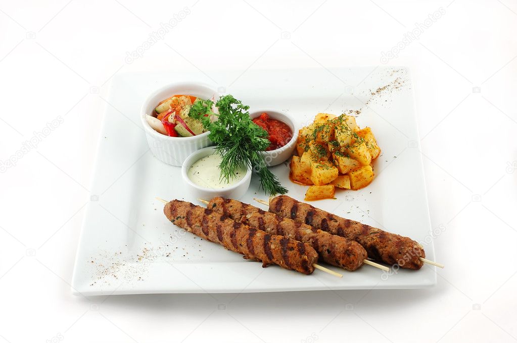 Barbecue with salad on a square plate