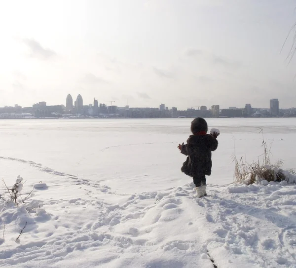 Mädchen am Ufer des zugefrorenen Flusses — Stockfoto