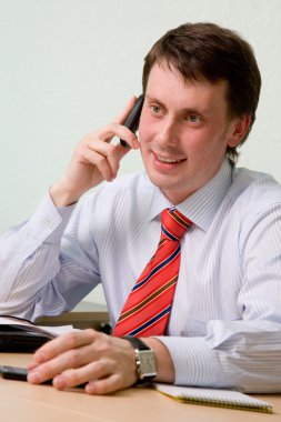 Businessman speaks by phone clipart