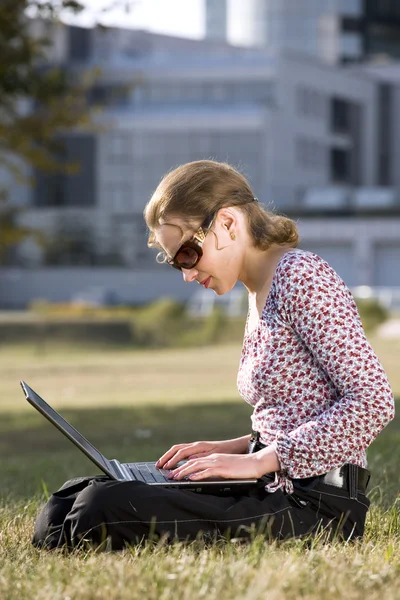 Mulher trabalhando sobre um computador portátil — Fotografia de Stock