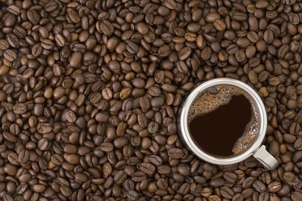 stock image Coffee cup on a coffee beans