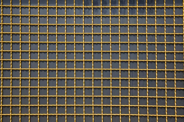 Yellow lattice on a black background — Stock Photo, Image