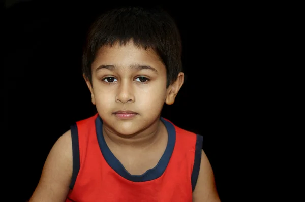 Um garoto indiano bonito que parece muito sombrio e triste — Fotografia de Stock