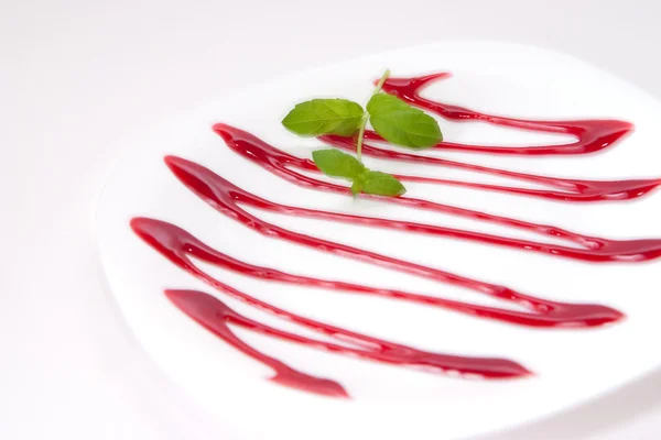 stock image Plate decorated with cherry sauce