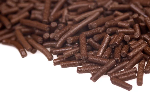 Polvilhas de chocolate no fundo branco. quadro — Fotografia de Stock