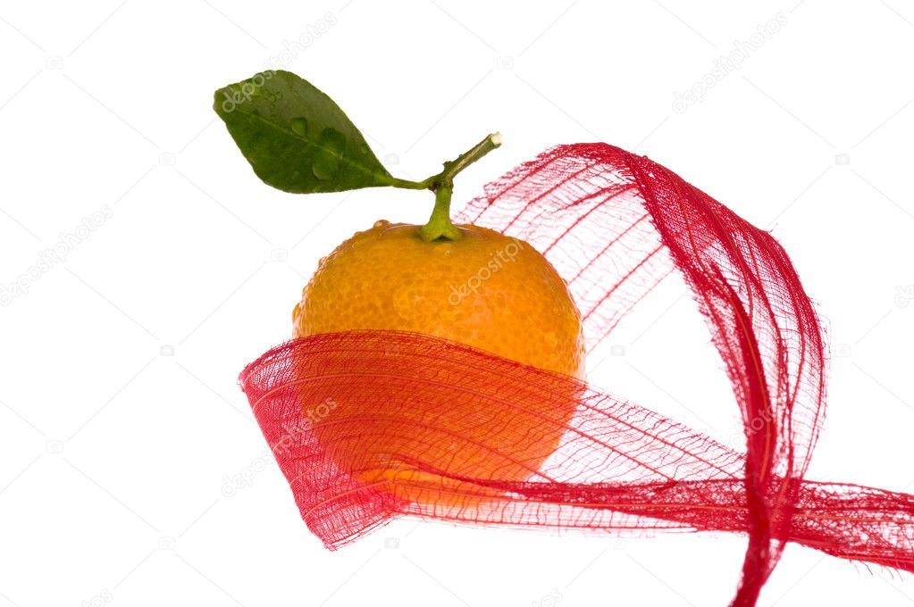 Christmas sweet in red bow. orange fruit