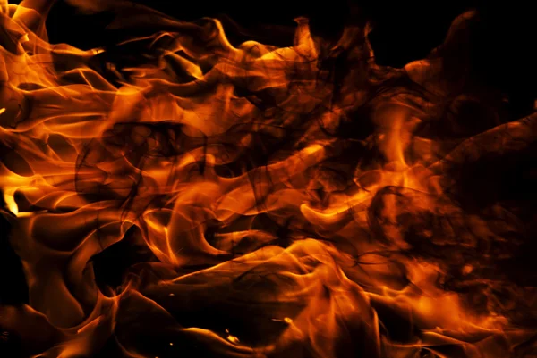stock image Close up of burning fire over black