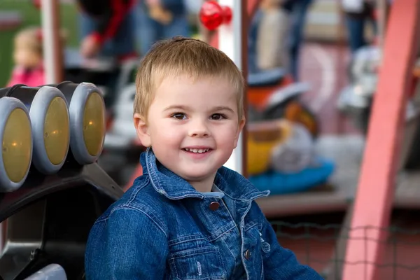 Cute toddler boy on a merry-go-round — Stock Photo, Image