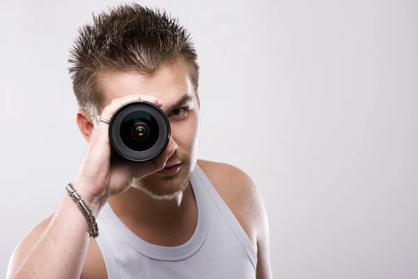 Man and lens — Stock Photo, Image