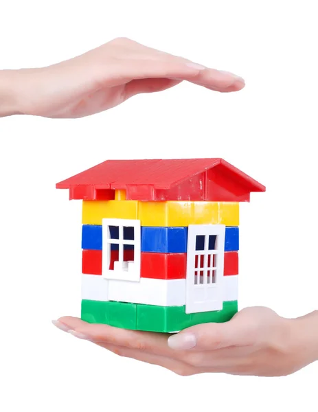 stock image Hands and toy colour house