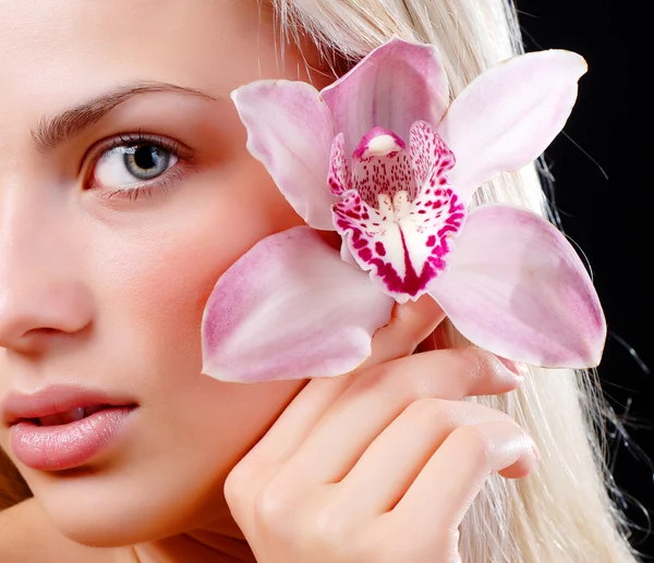 Face of woman and orchid — Stock Photo, Image