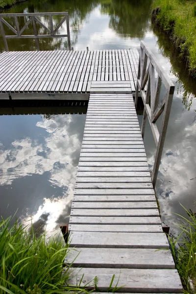 Wooden bridge and water — Stock Photo, Image