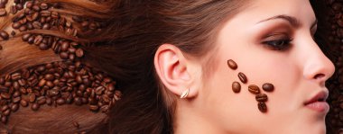 Woman's face with coffee beans clipart