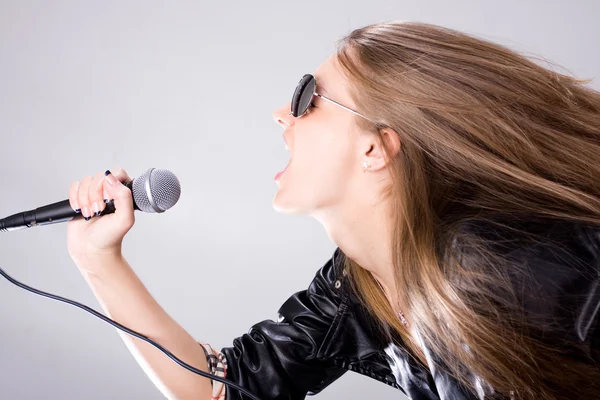 Young singer with microphone — Stock Photo, Image