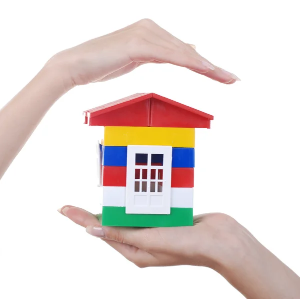 Hands and toy colour house Stock Image