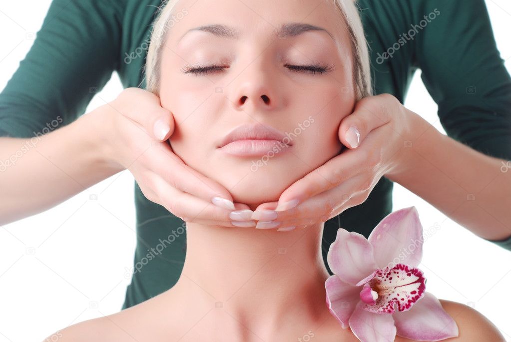 Face of beautiful young woman with delicate orchid