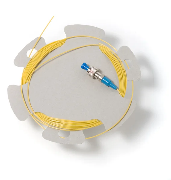 Optic cable with a connector on a cardbo — Stock Photo, Image