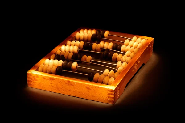 Old abacus on black background — Stock Photo, Image