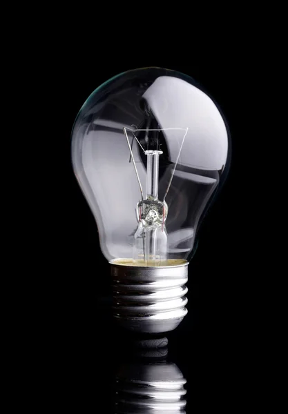 Photo of light bulb on black background — Stock Photo, Image