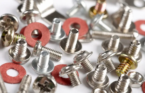 Screws, bolts and nuts on a white backgr — Stock Photo, Image