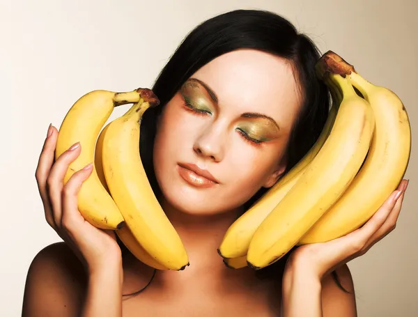 Brunette with bananas Royalty Free Stock Photos