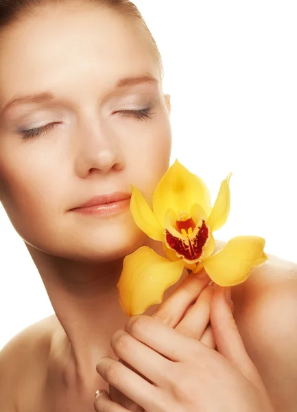 Young woman with yellow orchid — Stock Photo, Image