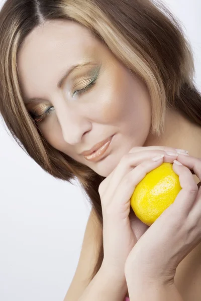 Mujer joven sosteniendo un limón — Foto de Stock