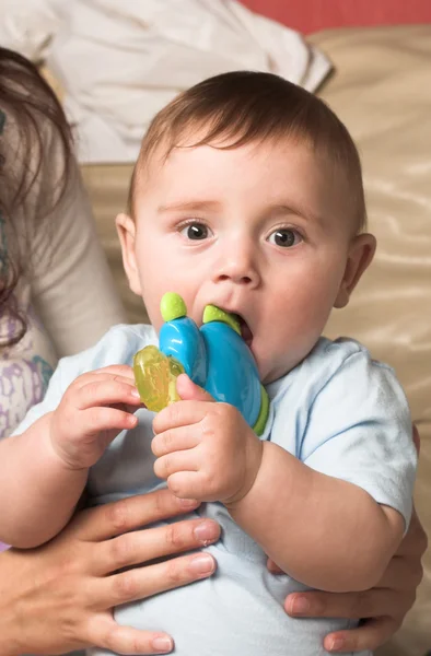Child nibbling a toy — Stock Photo, Image