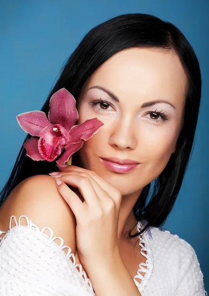 Woman with orchid flower Royalty Free Stock Photos