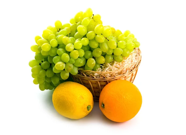 Basket with green grapes and citruses — Stock Photo, Image