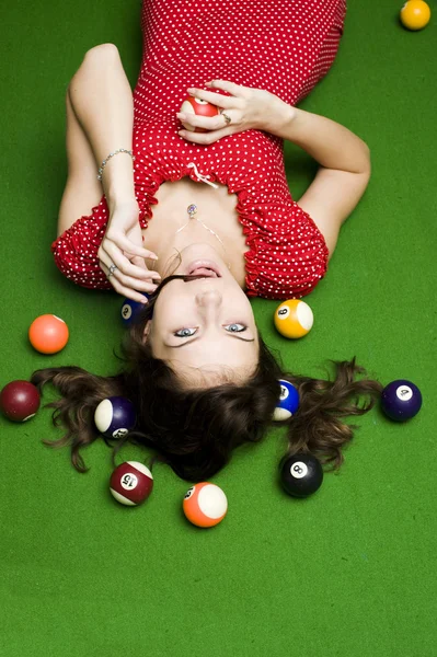 Beautiful girl on a billiards table — Stock Photo, Image