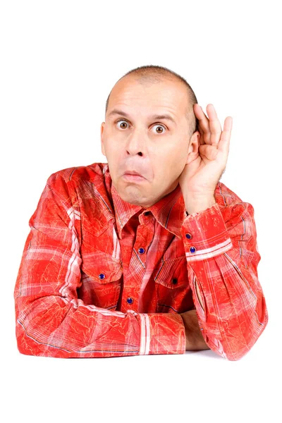 Man in red shirt with hand on his ear — Stock Photo, Image