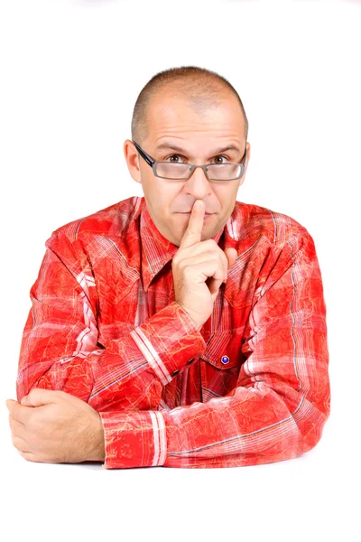 Średniej wieku człowiek z palcem na ustach — Zdjęcie stockowe
