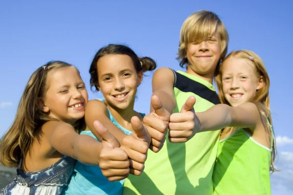 Vier jonge positieve kinderen Stockfoto