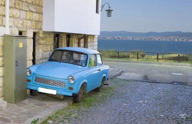 Old car in the street clipart