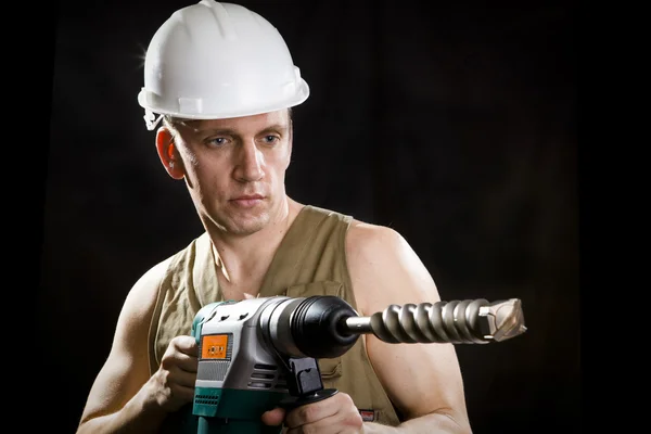 The builder in a protective helmet — Stock Photo, Image