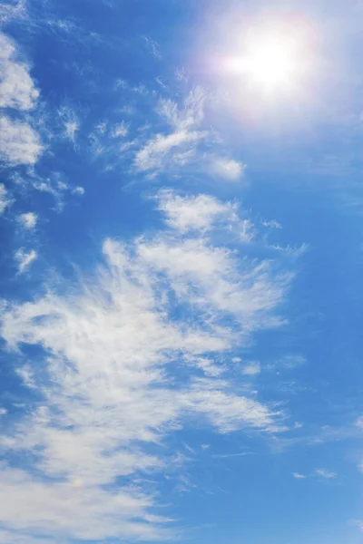 stock image Bright azure sky with clouds and sun