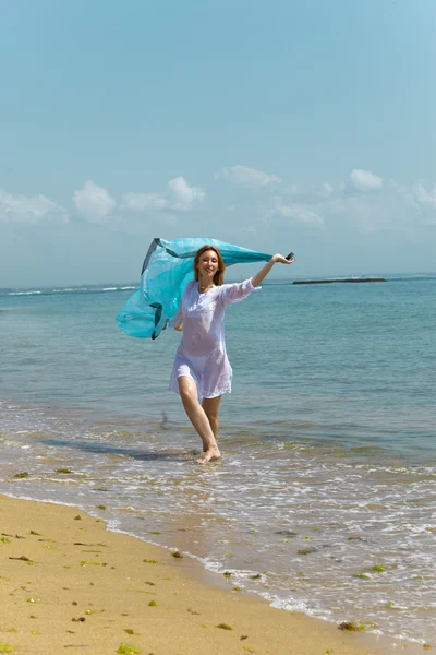 Молодая изящная женщина на берегу океана — стоковое фото