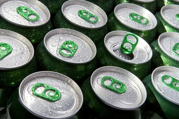 Aluminum cans in drops of water with key — Stock Photo, Image
