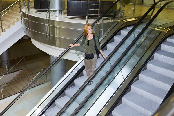Young woman on the escalator — Stock Photo, Image