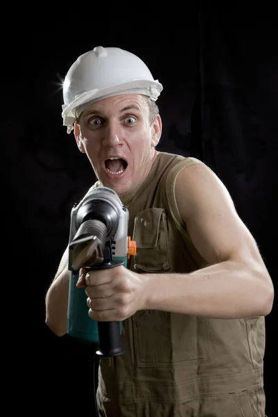 The builder in a protective helmet hold — Stock Photo, Image
