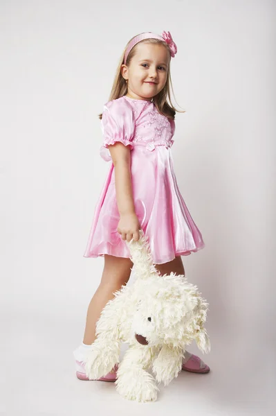 Pěkná mladá dívka v růžovém na světlém pozadí s — Stock fotografie