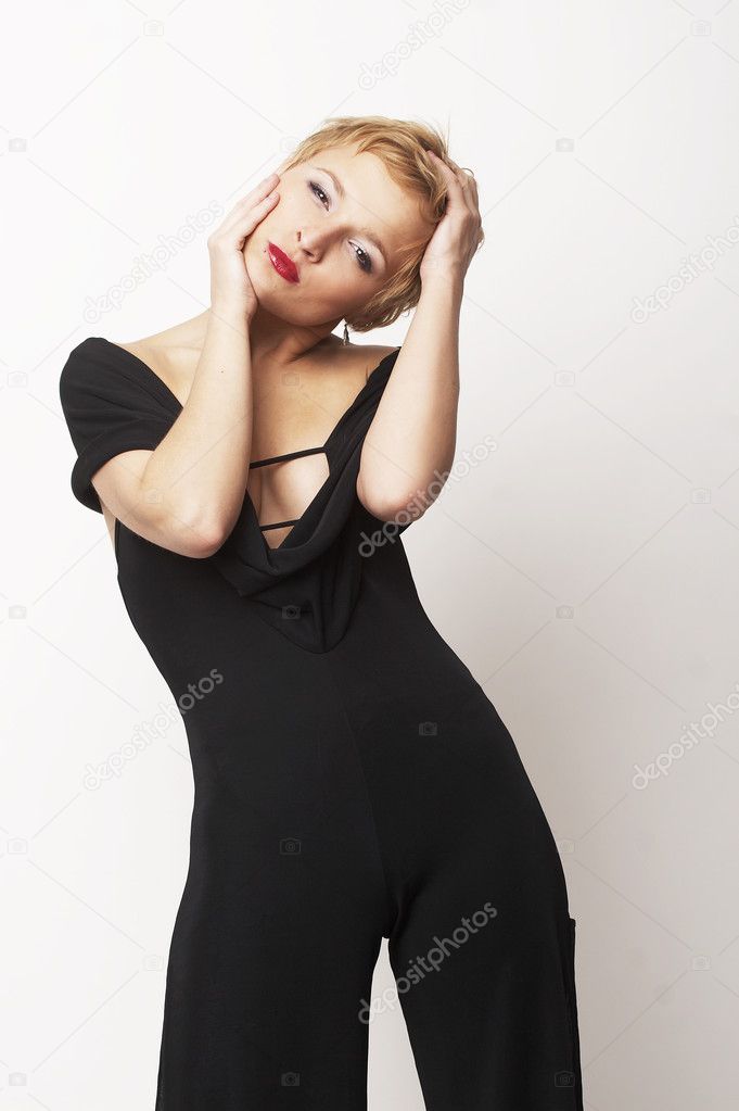 Sexy blond girl standing in black dress