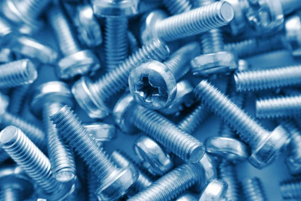 stock image Bunch of screws as background in blue