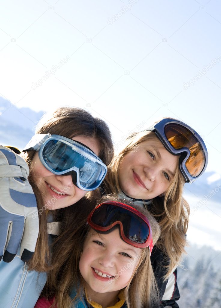 Young smiling girls on ski camp