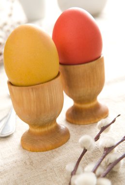 Easter eggs in egg cups clipart