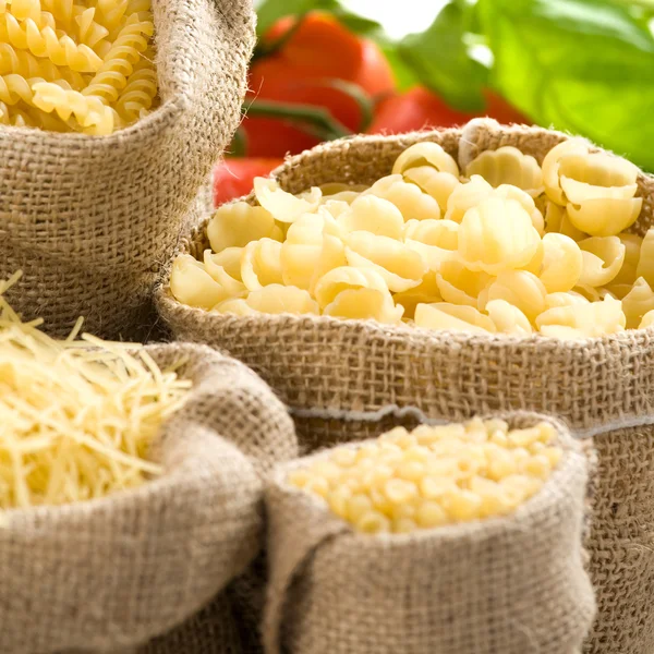 Various macaroni in small sacks — Stock Photo, Image